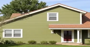 olive drab green house with light brown roof