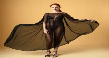 A 22-year-old woman with very fair skin and long natural red hair tied back stands in a softly Li צt, minimalist studio. She wears a flowing sheer black transparent dress made of sheer that subtly reveals the shape of her body underneath in an artistic, high-fashion style. The dress clings slightly to her form, hinting at her figure with sensual elegance. Her breast and nipples are clearly visible through the sheer fabric, adding a daring and provocative edge to the look. She stands in black sandal heels with thin straps and a modest heel, similar to luxury designer footwear. Her expression is calm and introspective, her posture graceful. The background is warm beige, the light emphasizing the soft textures of the fabric and her smooth skin. The overall atmosphere is intimate, aesthetic, and refined—blending fashion and fantasy.