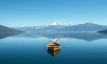 A small wooden boat is floating on the lake, reflecting the mountains in the clear blue sky, distant snow-capped mountain peak adds depth to the scene, soft ripples on the lake, natural beauty and tranquility