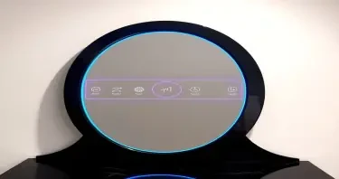 A tall oval mirror with a flawless reflective surface, framed in polished black onyx. A wide electric blue LED ring surrounds the mirror near its edge, with a thinner purple ring nested inside. Between the rings, glowing symbols and interface glyphs pulse gently. The background is softly lit, allowing the mirror and its embedded data to shine clearly.