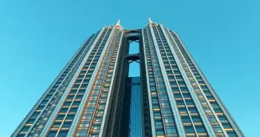 neo art deco commerical skyscraper with beams similar to the twin towers but different shape