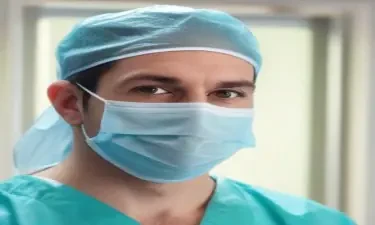 Male surgeon gowned for surgery