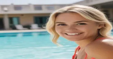 average blonde woman at hotel pool smiling at camera
