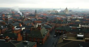 High aerial view of Victorian London. Whisps of smoke rising from chimneys. Rich colors. Rain. High detail.