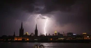 The skyline of cologne with a huge thunderstorm going down.