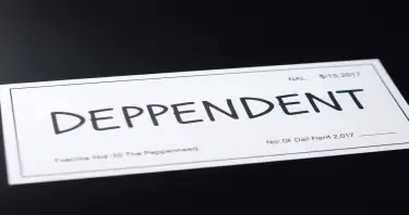A paycheck with "DEPENDENT" stamped on it