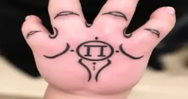 A Filipino bear paw tattoo with a Gemini symbol in the center