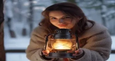 a young woman holding an antique lantern by its curved iron handle, not touching the glass body, the lantern has a metal ring handle attached on top, glowing softly, realistic lighting, snowy forest background