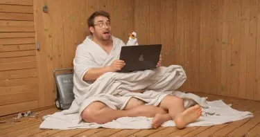 **Image Prompt for Feature Image:**  A cartoon-style illustration of a software developer sitting in a wooden sauna, sweating profusely, surrounded by floating lines of buggy code and error messages. The developer looks both frustrated and amused, with a towel around their neck and a laptop balanced on their knees. In the background, a thermometer is maxed out and a rubber duck (a classic debugging mascot) wears sunglasses. The overall vibe is lighthearted and playful, clearly blending the themes of sauna heat and the "sweat" of debugging code.