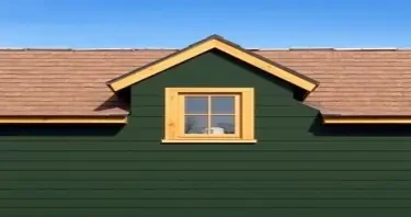 dark olive drab green house with light brown roof and wooden window trim