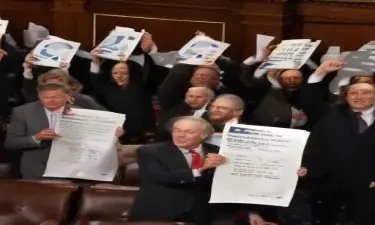 The entire US senate cheering and one of them is holding a paper with the solution to all problems