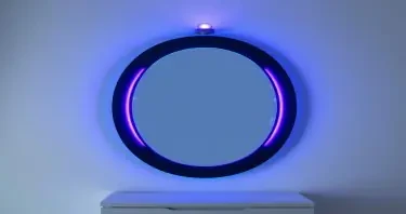 A vertical oval mirror with a dark onyx frame, set against a clean, ambient-lit background. A soft blue halo wraps the edge of the mirror, while a smaller purple ring pulses closer to the center. Between the two rings, illuminated glyphs and techno-data shift in patterns. At the top of the unit, a glowing beacon emits a subtle upward beam — symbolic and minimal, not overpowering.