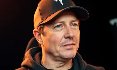 elon musk wearing a baseball cap with a Tesla logo