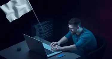 A Software-Developer working at his laptop with code line on the display. The developer is raising a white flag.