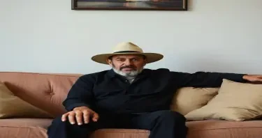 man in a hat on a couch