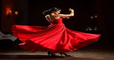 A beautiful Spanish full bodied woman tango dancer in a red silk dress spinning around
